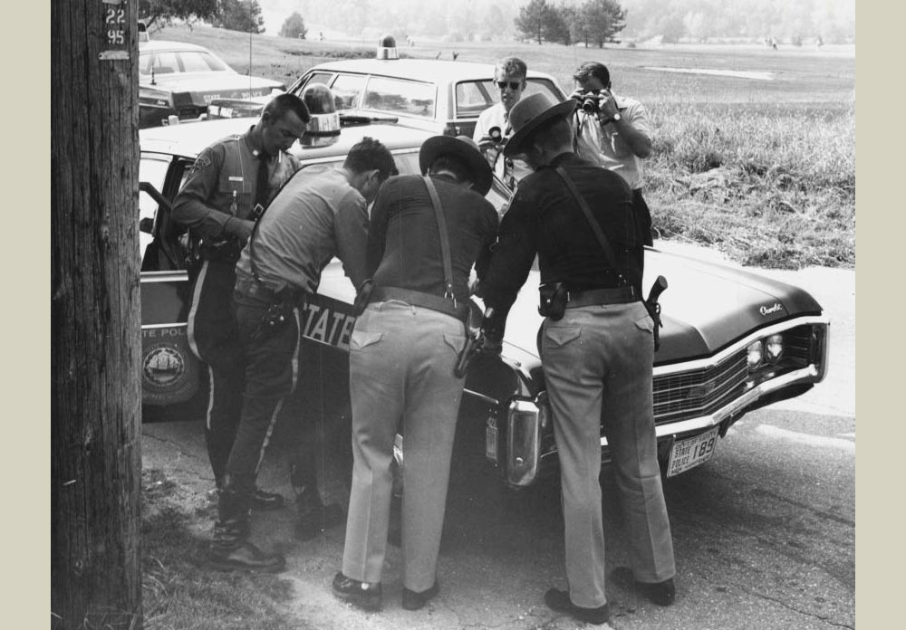 New Hampshire police officers and car